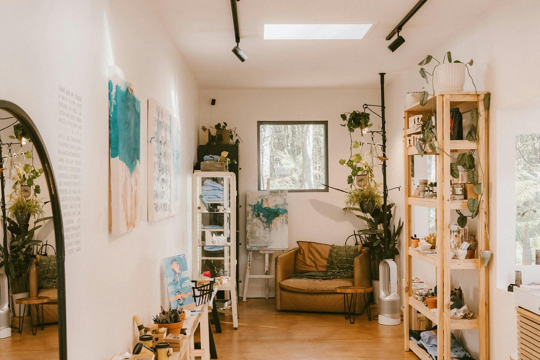 The inside of Blue Tree Gallery, A renovated shipping container with artwork over the walls