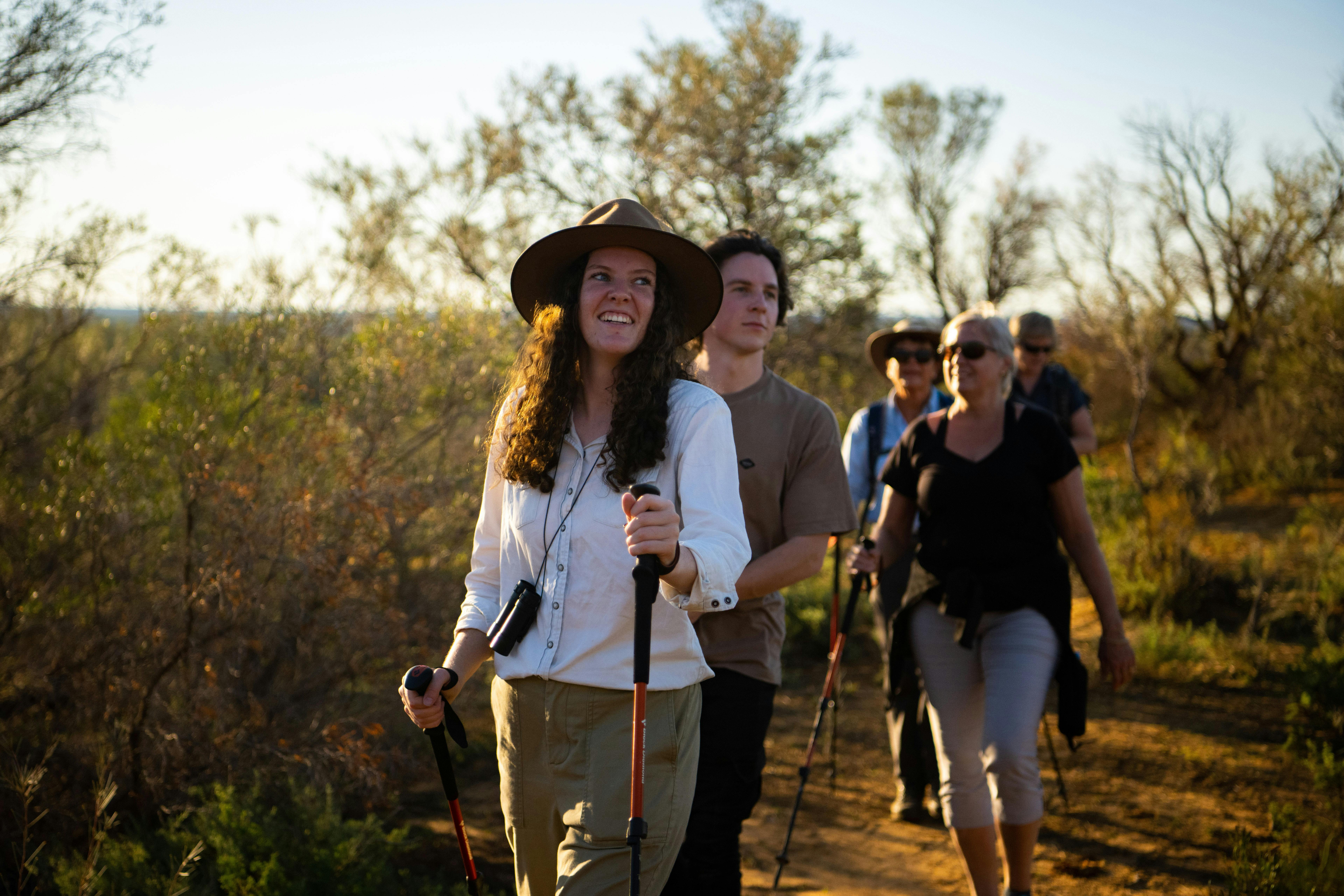 A guide takes a group of people for a walk on the Murray River
