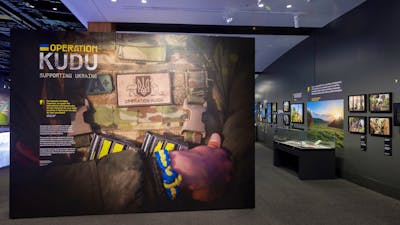 entrance to gallery with main photo of soldier in uniform, arms crossed