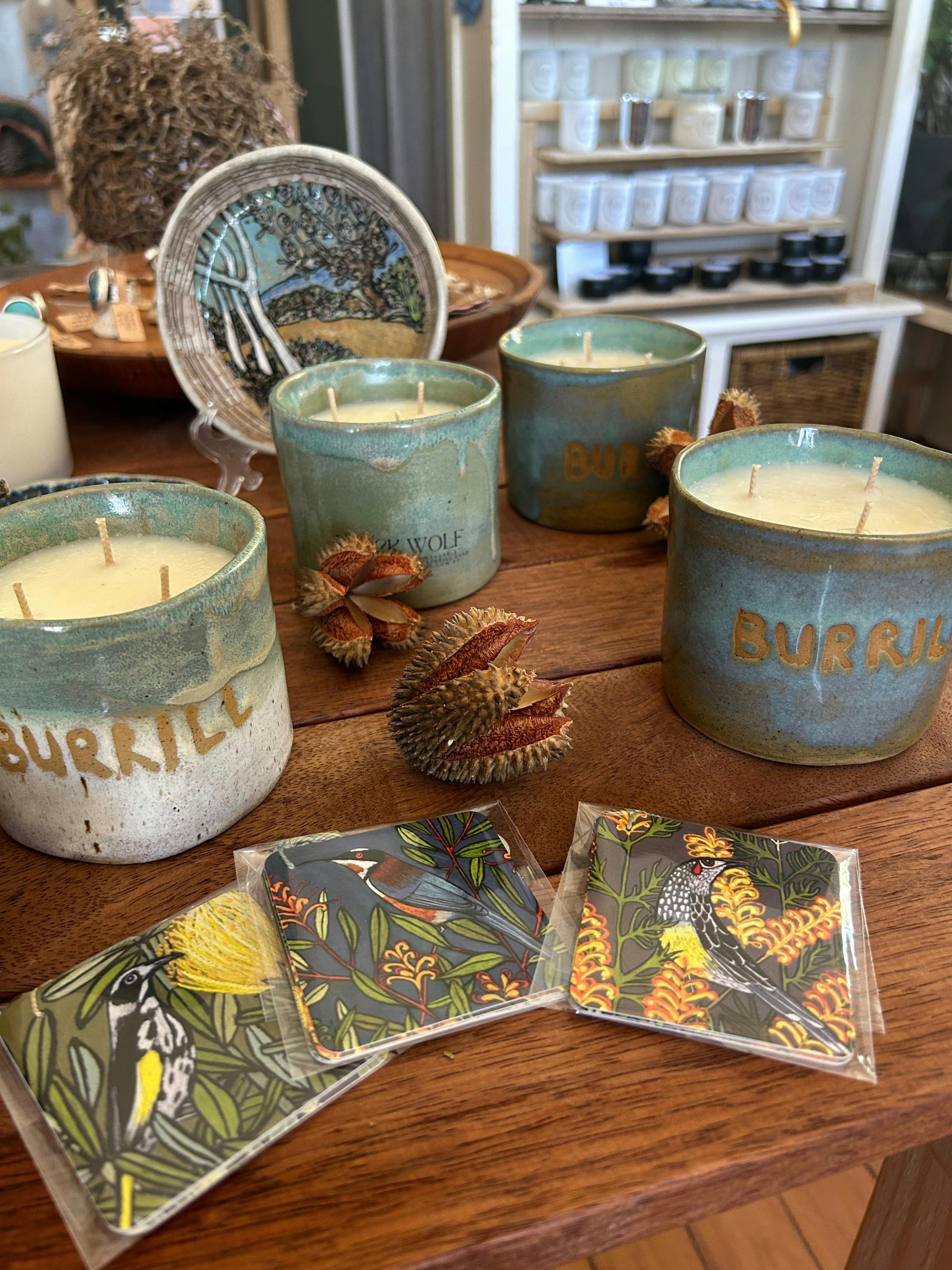 Candles made with vessels the blues and greens of the lake in the glaze .