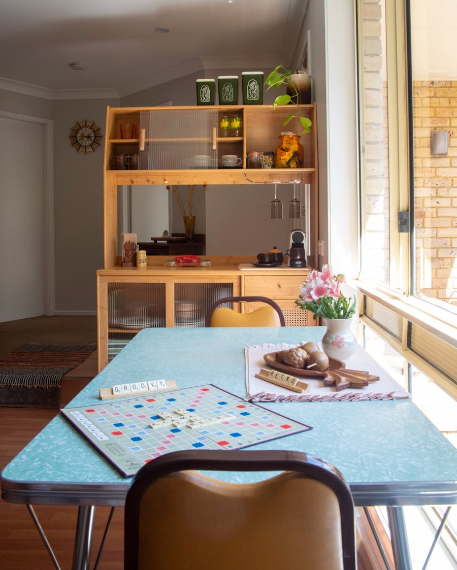 Modern vintage style kitchen hutch with retro styling. Laminate table and two chairs