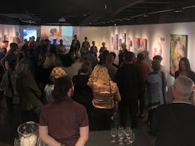 Photo of crowd at exhibition opening of WOMAN exhibition, 2023