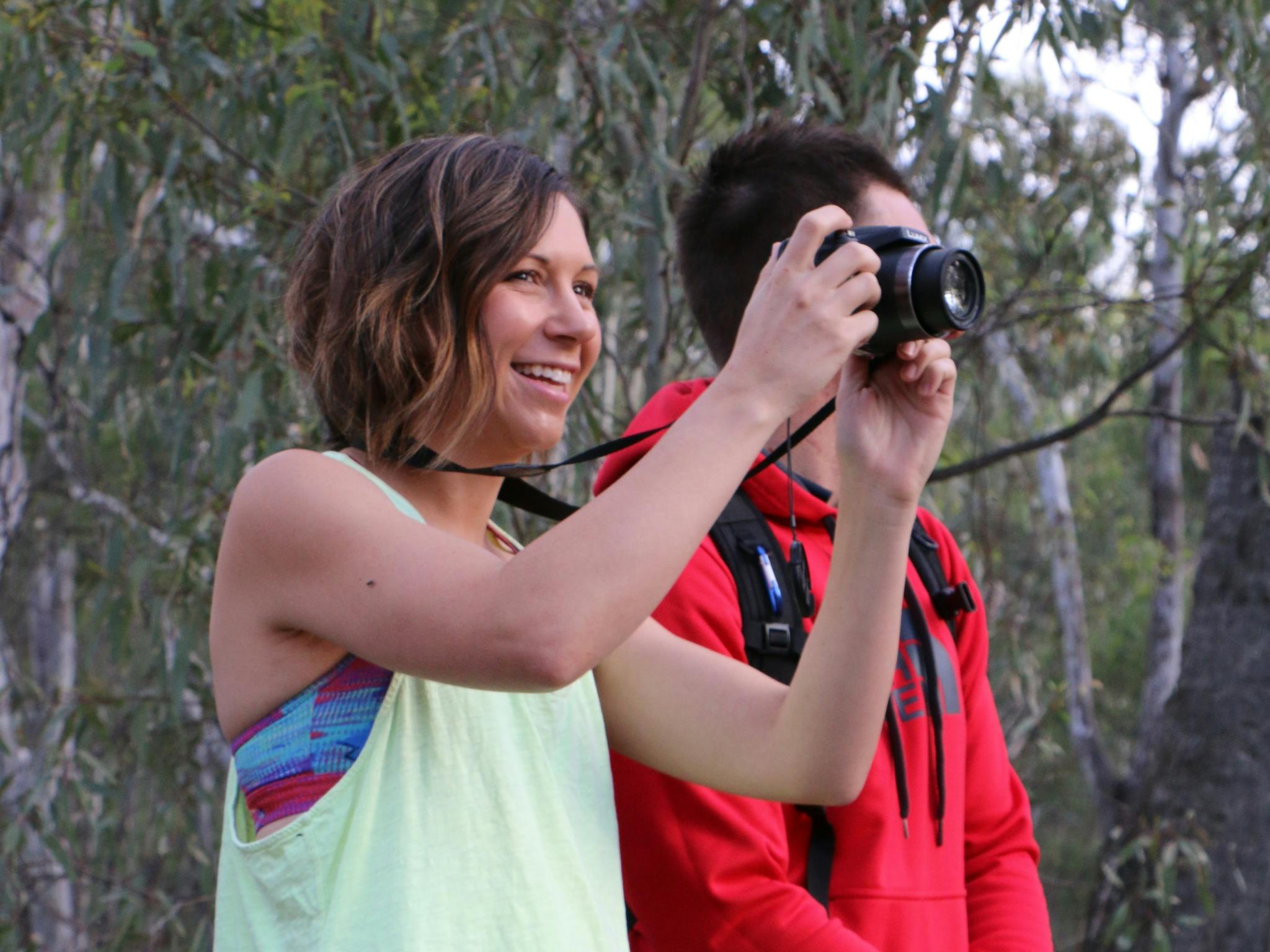 A couple taking photos of the magnificent forest
