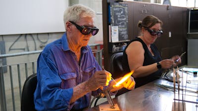 Participants learning beadmaking
