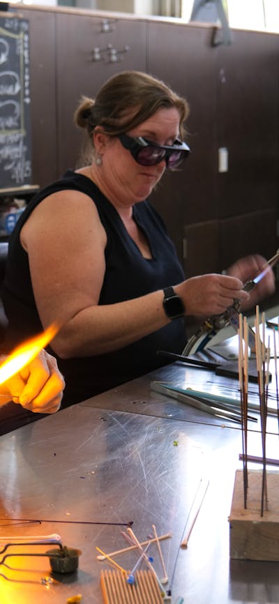 Participants learning beadmaking
