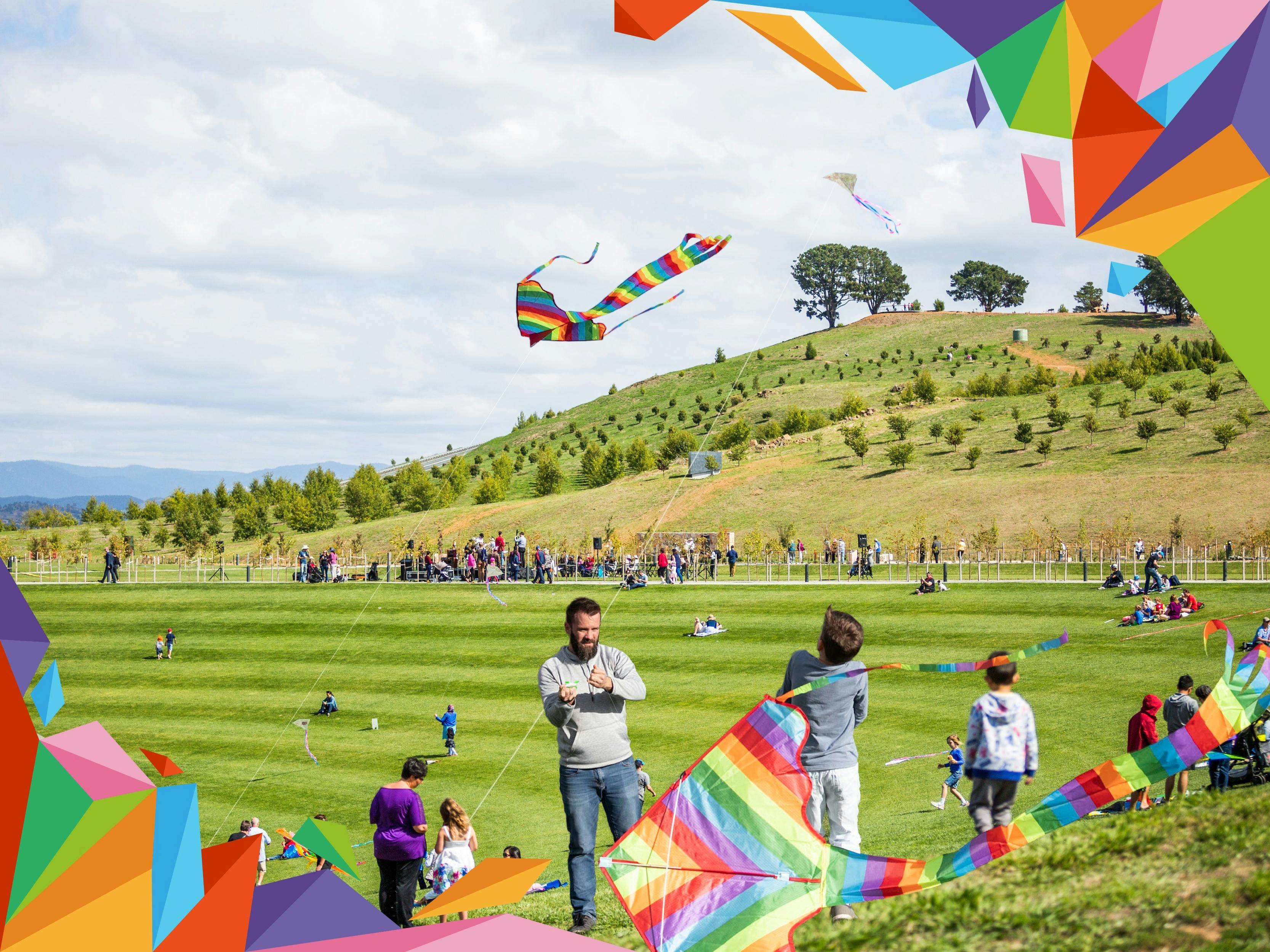 Families flying kites outdoors with colourful graphic overlay