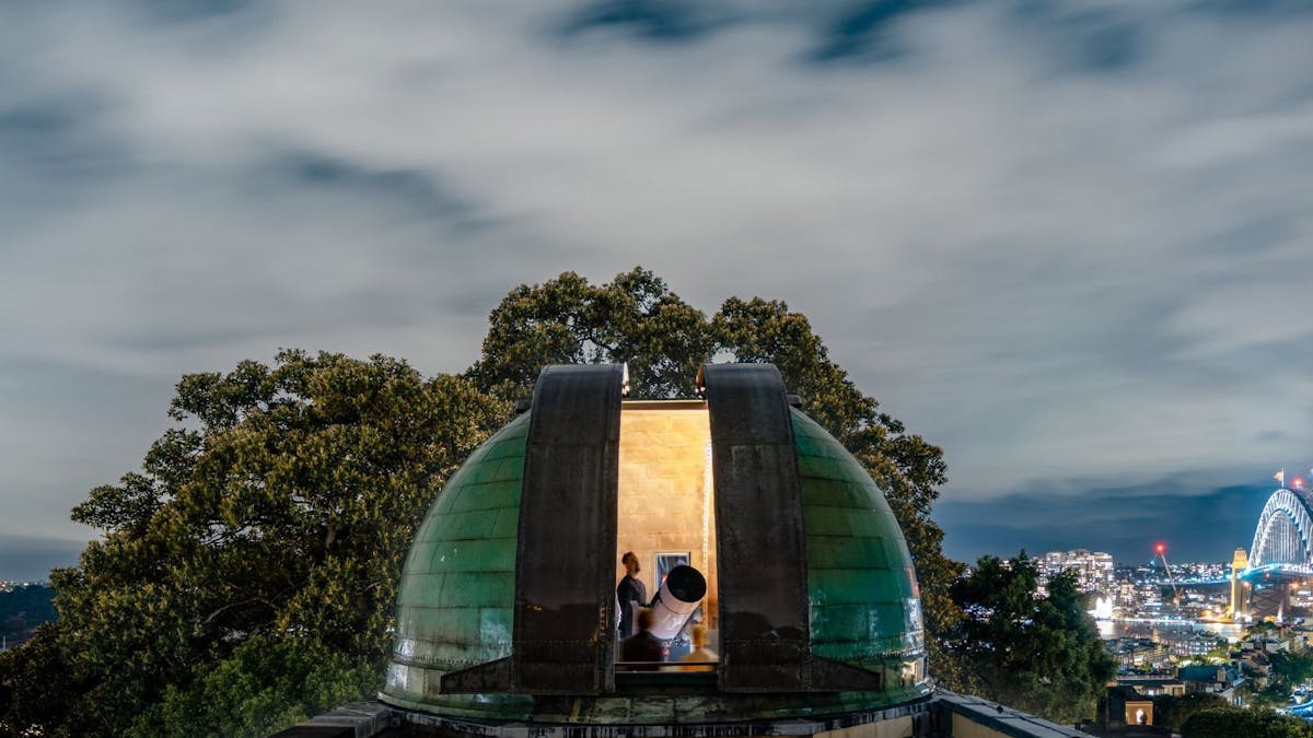 A man star gazing using a telescope