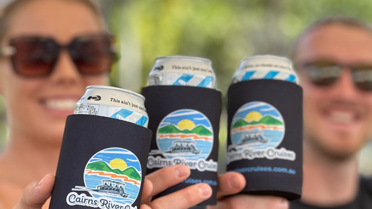 Friends cheersing complementary drinks in Cairns River Cruise Koozies