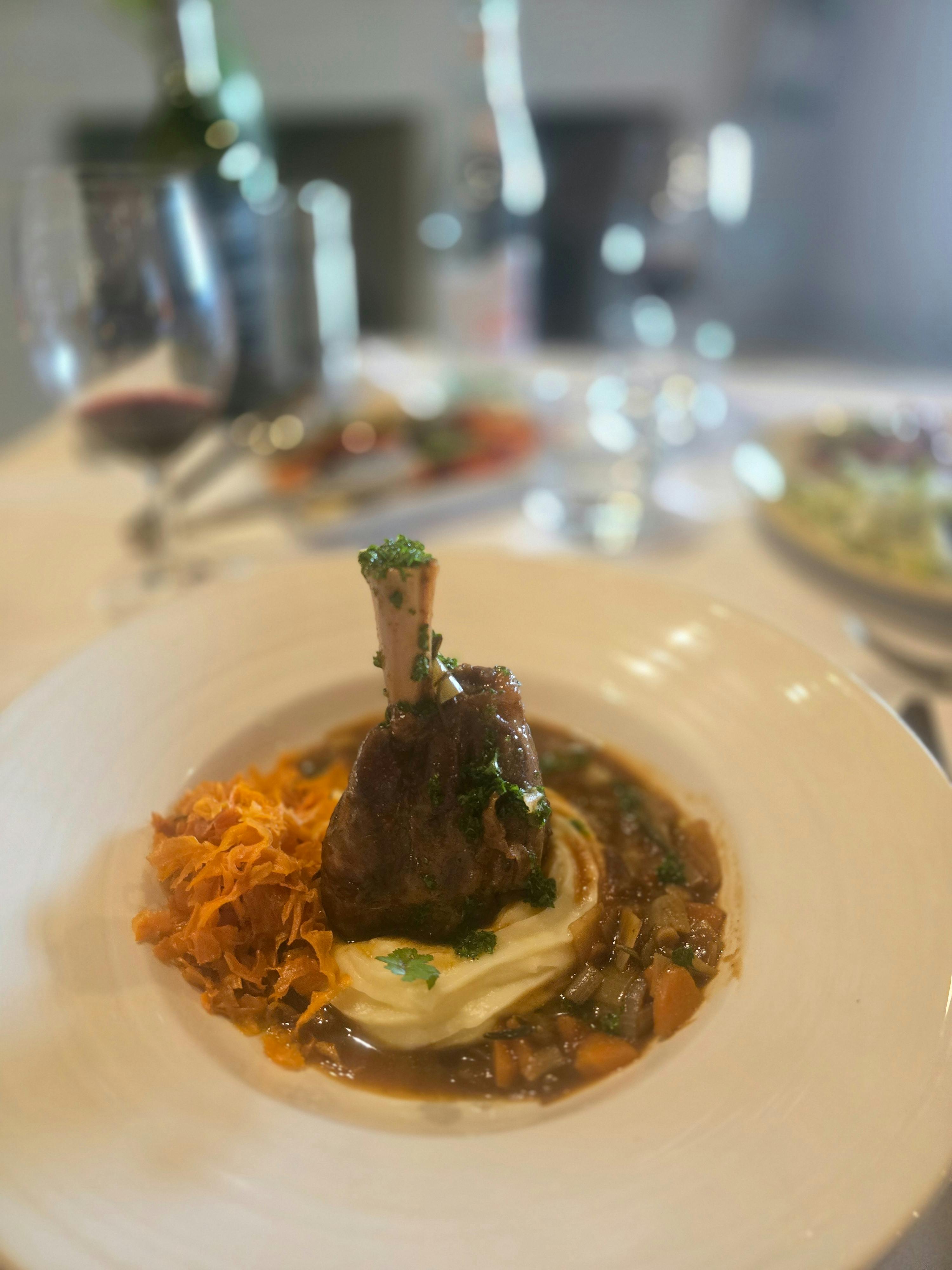 Elegant French cuisine, beautifully plated and served on crisp white linen.