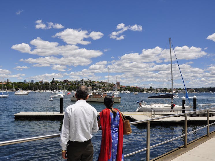 Sydney Bus Tour is at Rose Bay. Elderly couple who joined the tour is enjoying the view of Harbour