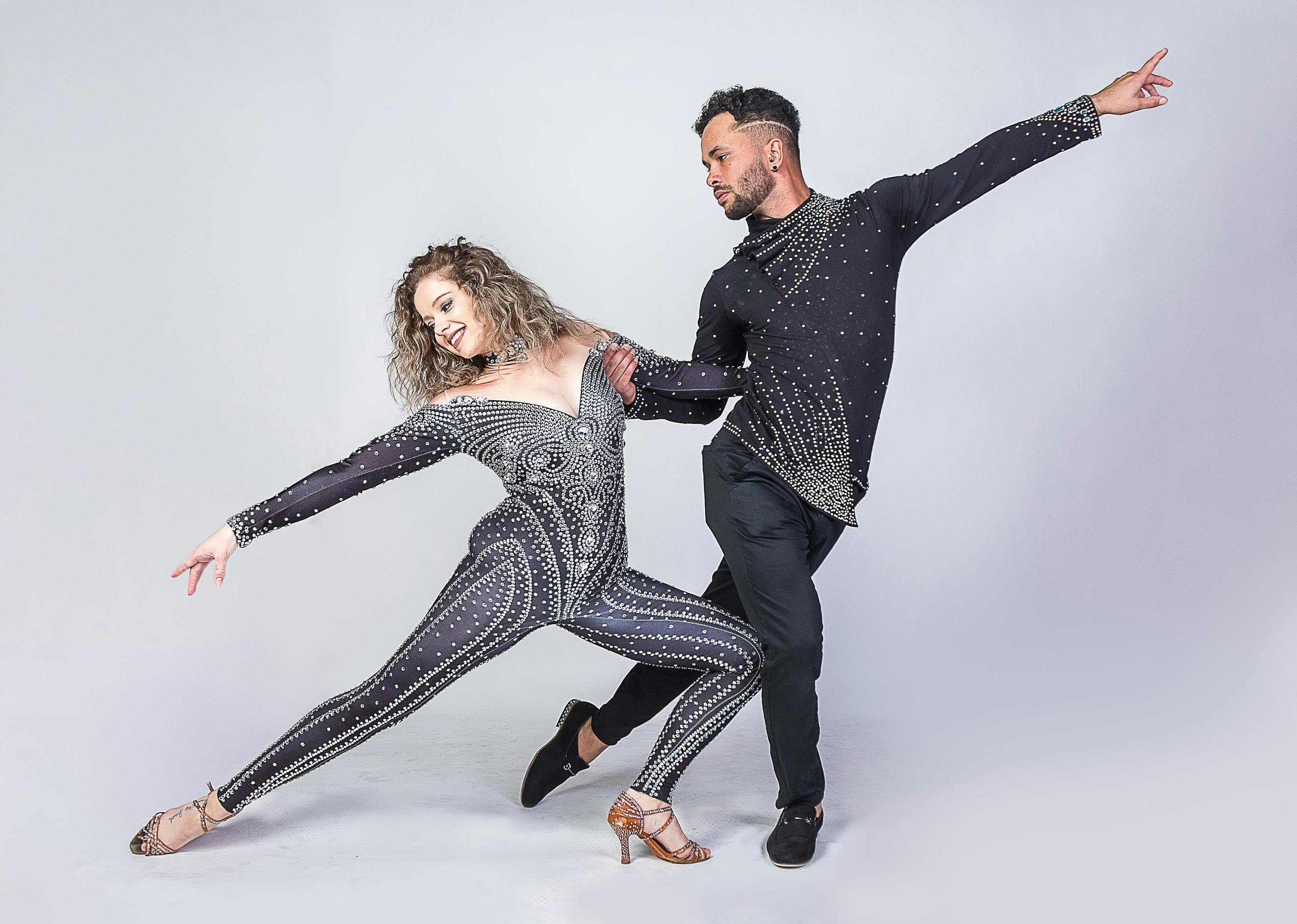 Professional dancers posing with lady in lunge supported by man