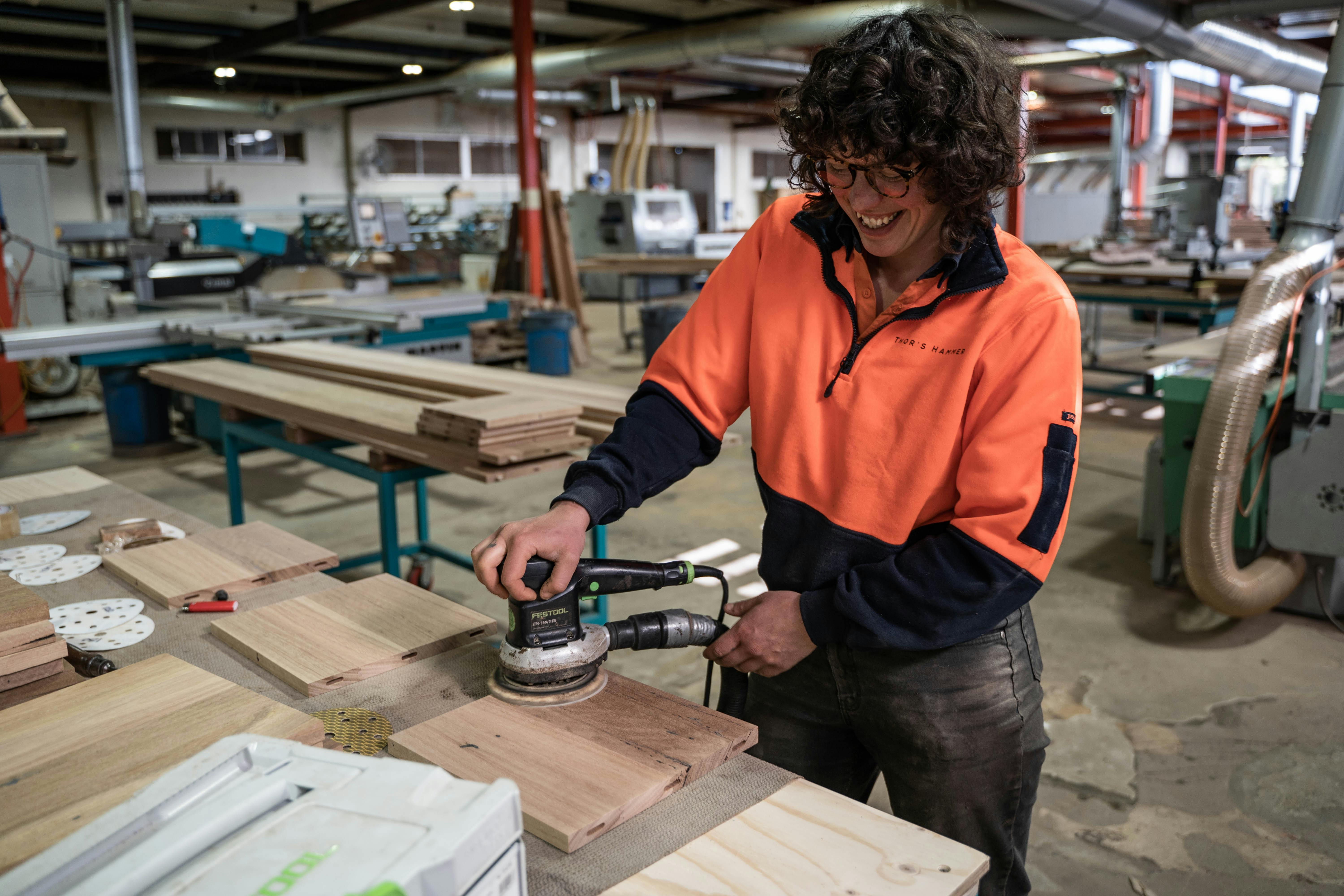 Staff member Lola demonstrating in the workshop