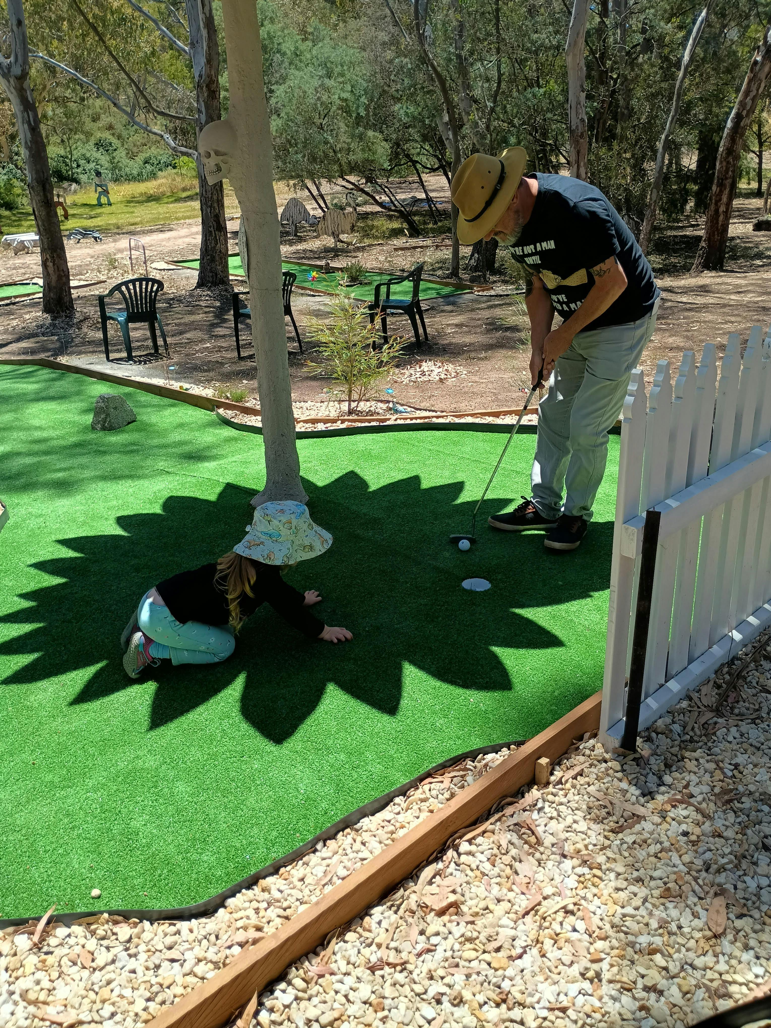 Intergenerational Mini Golf beneath the Ghost Gum sculpture.