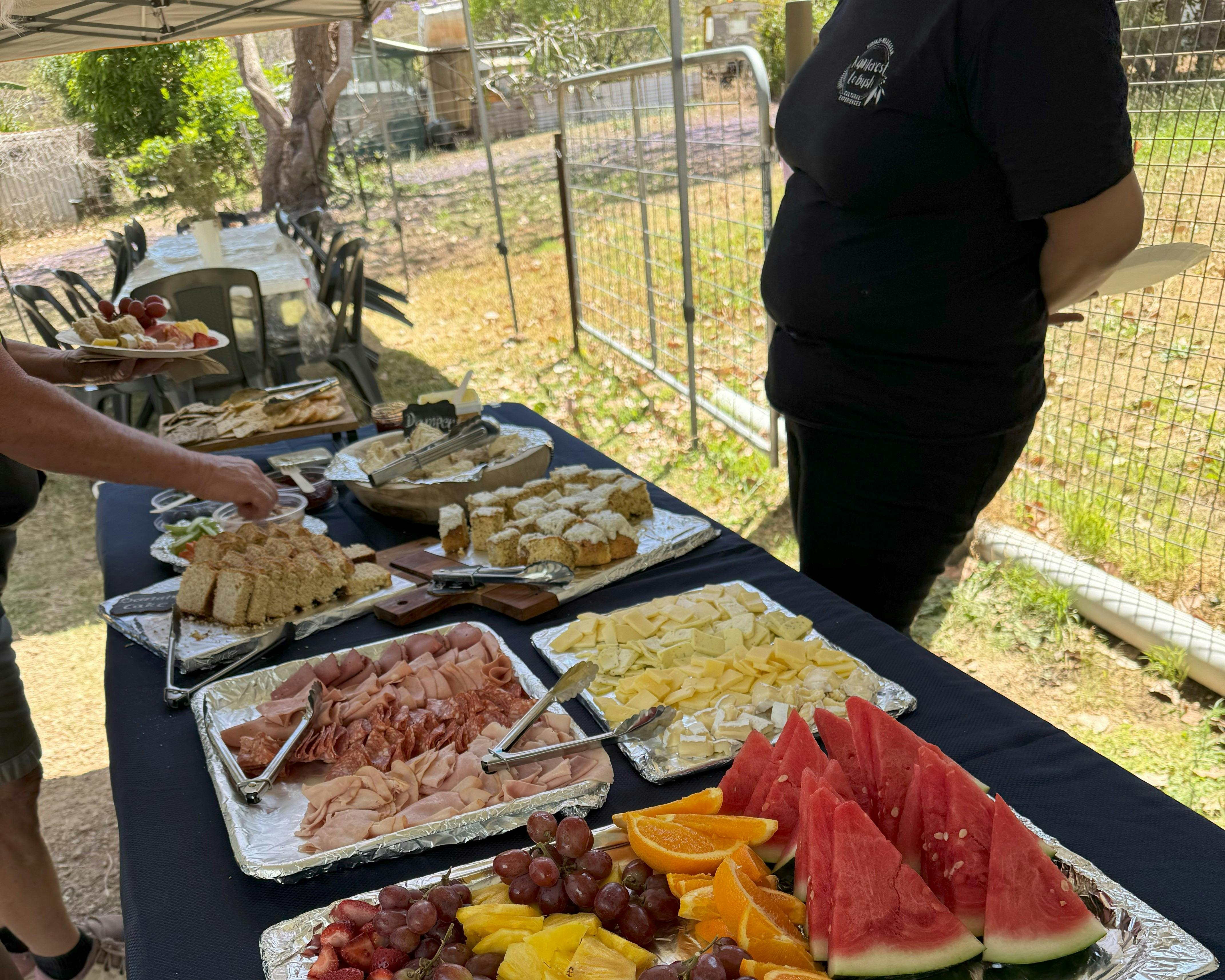Lunch platters of fruit, hams, and cheeses are served for the tour
