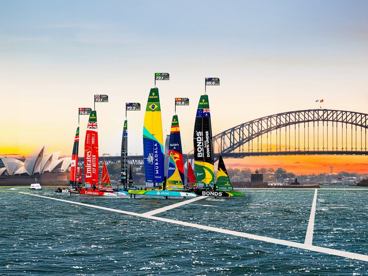 Six SailGP F50 boats fly across Sydney Harbour in front of the Opera House and Sydney Harbour Bridge