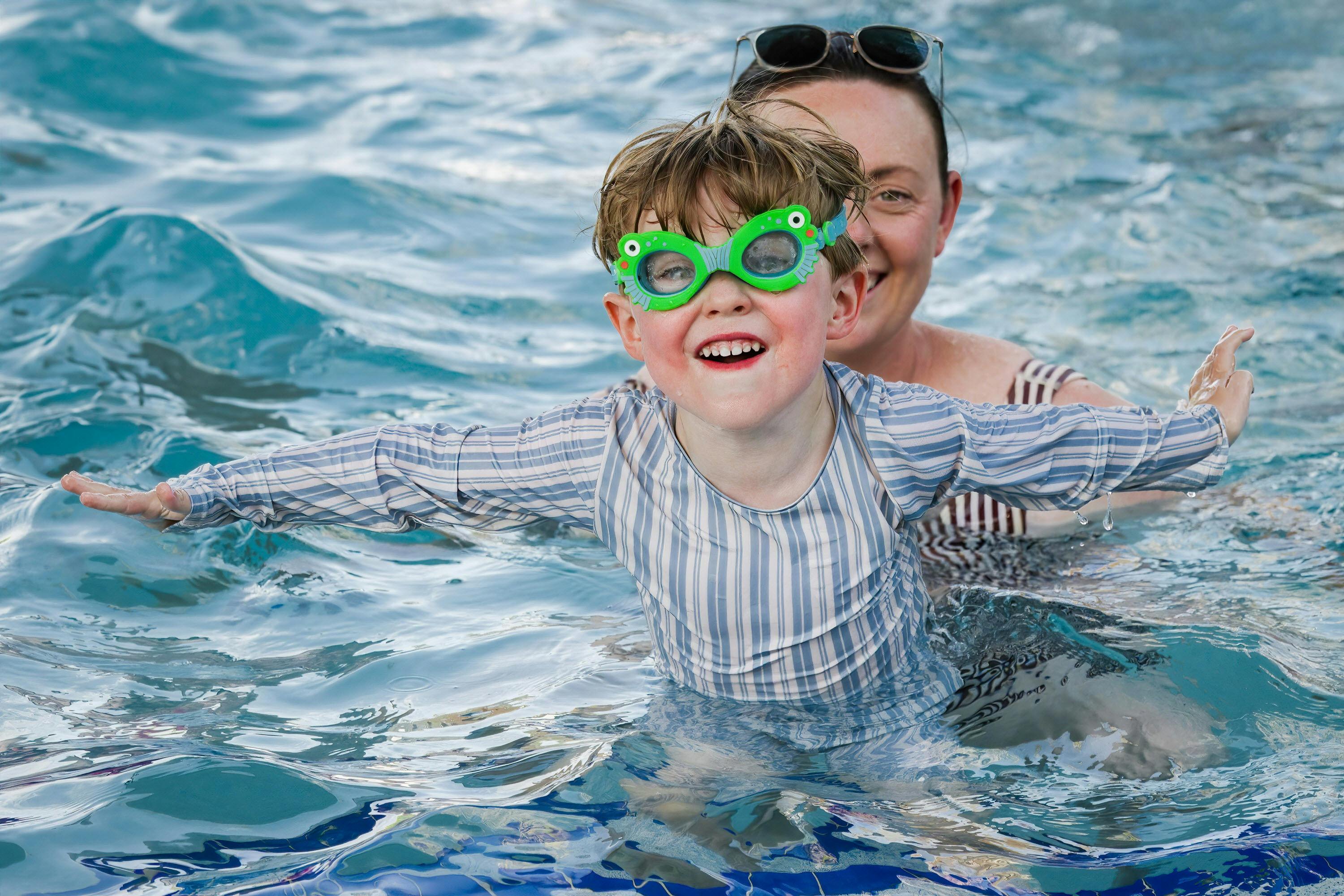 A child and adult in the swimming pool