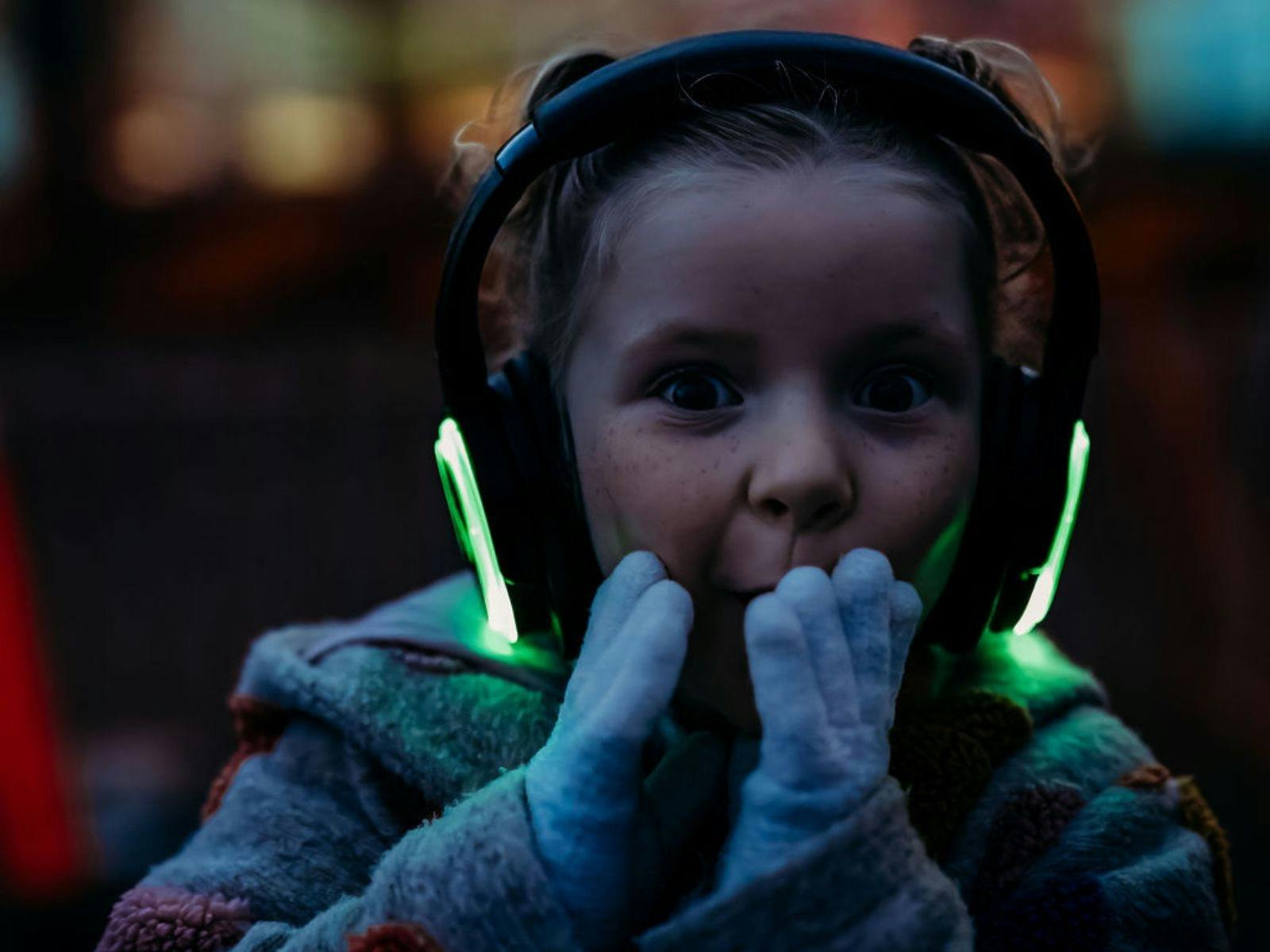 Child with glowing headphones at the Strahan Lightshow on the Strahan Post Office.