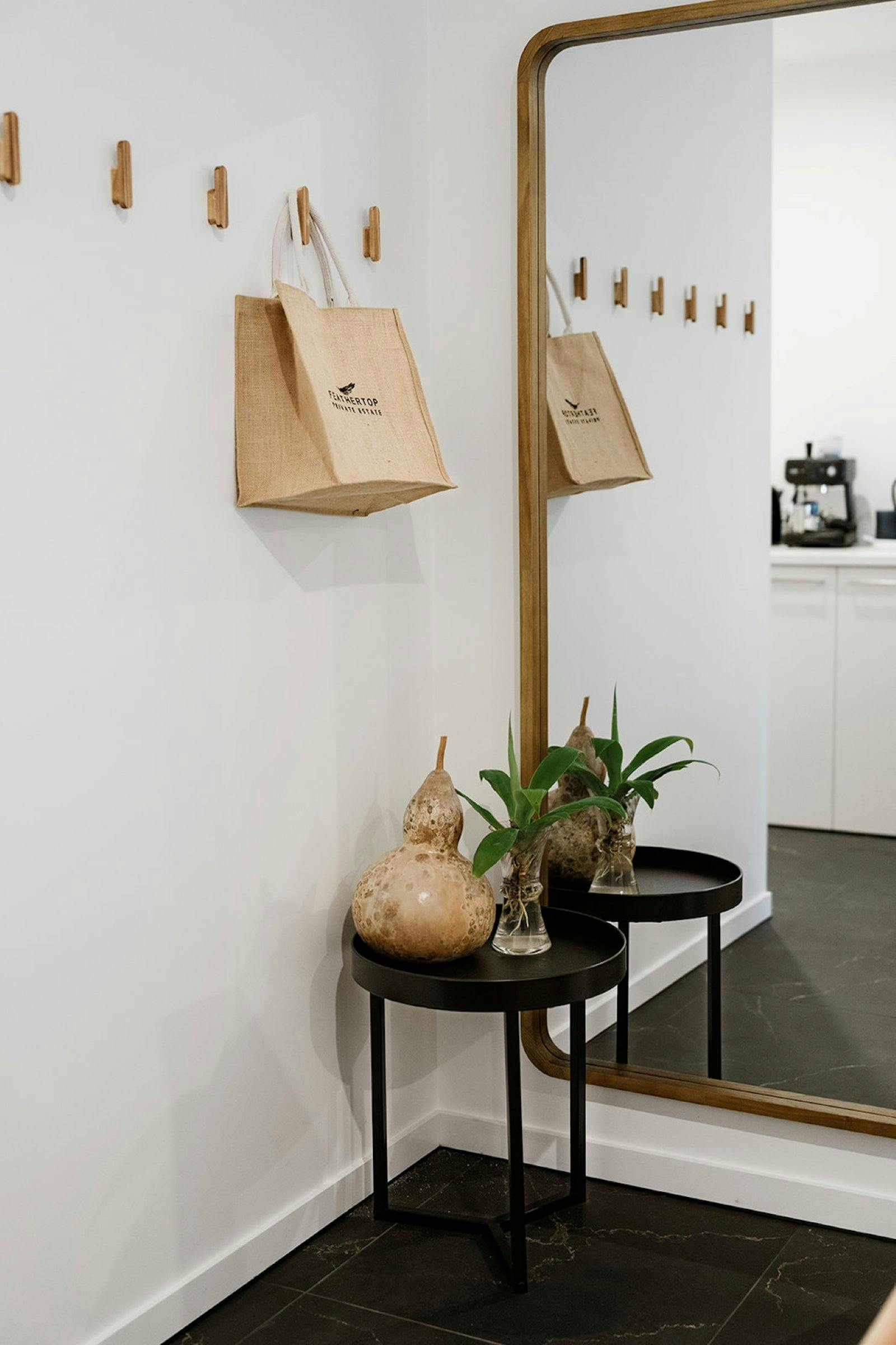 a table with decorations and a plant against a mirror