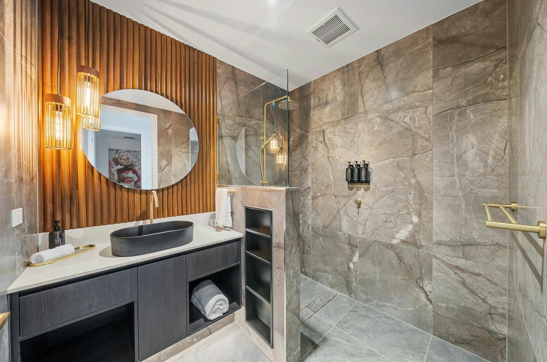 A beautifully finished private villa bathroom featuring warm timber details and modern amenities..