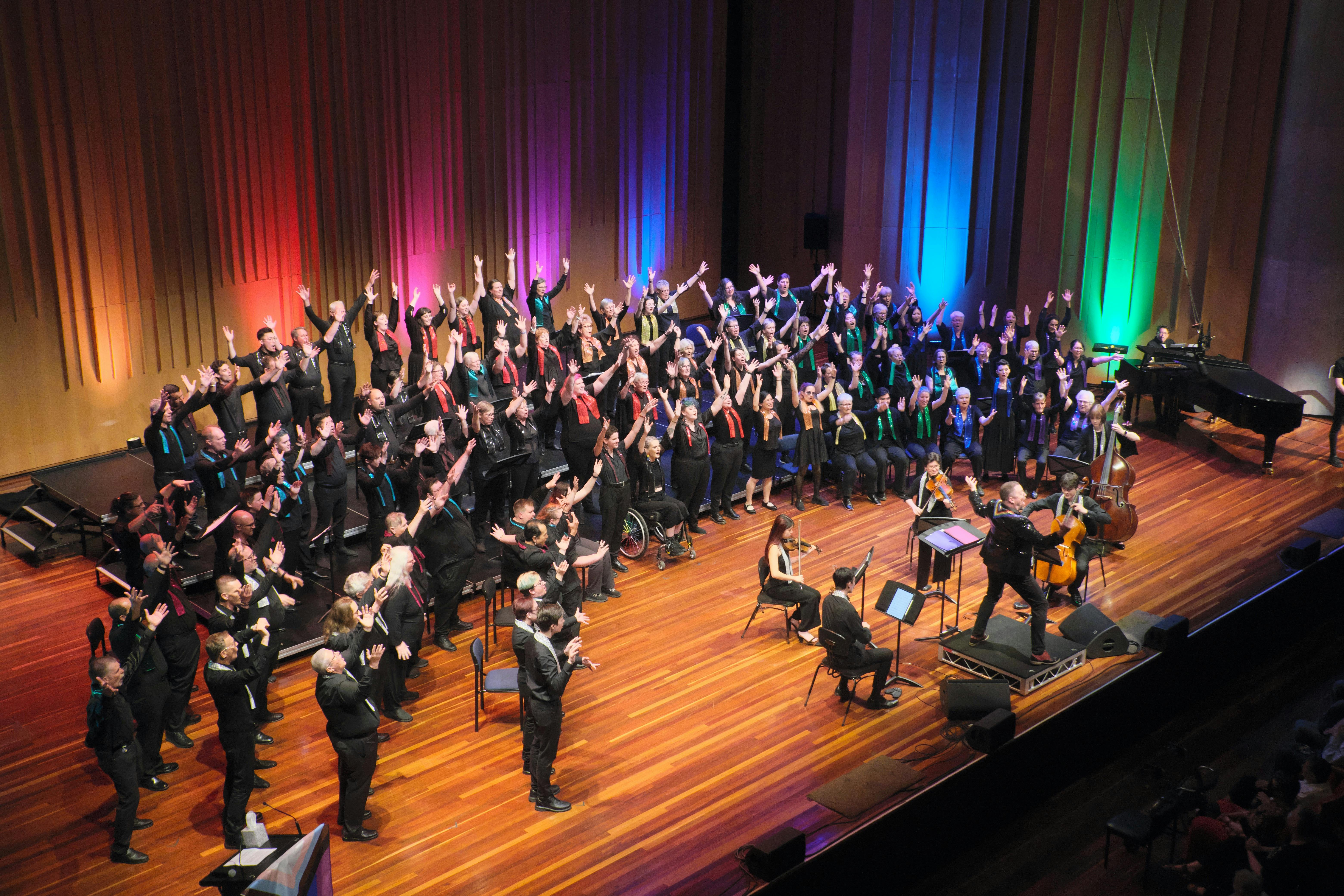 choir members and orchestra on stage performing