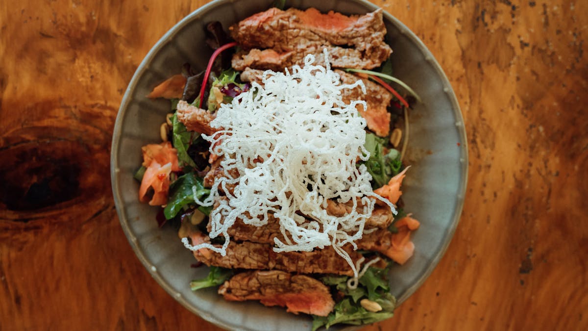 Thai beef salad with crispy noodles, fresh greens and peanuts at Sidewalk Café Airlie Beach
