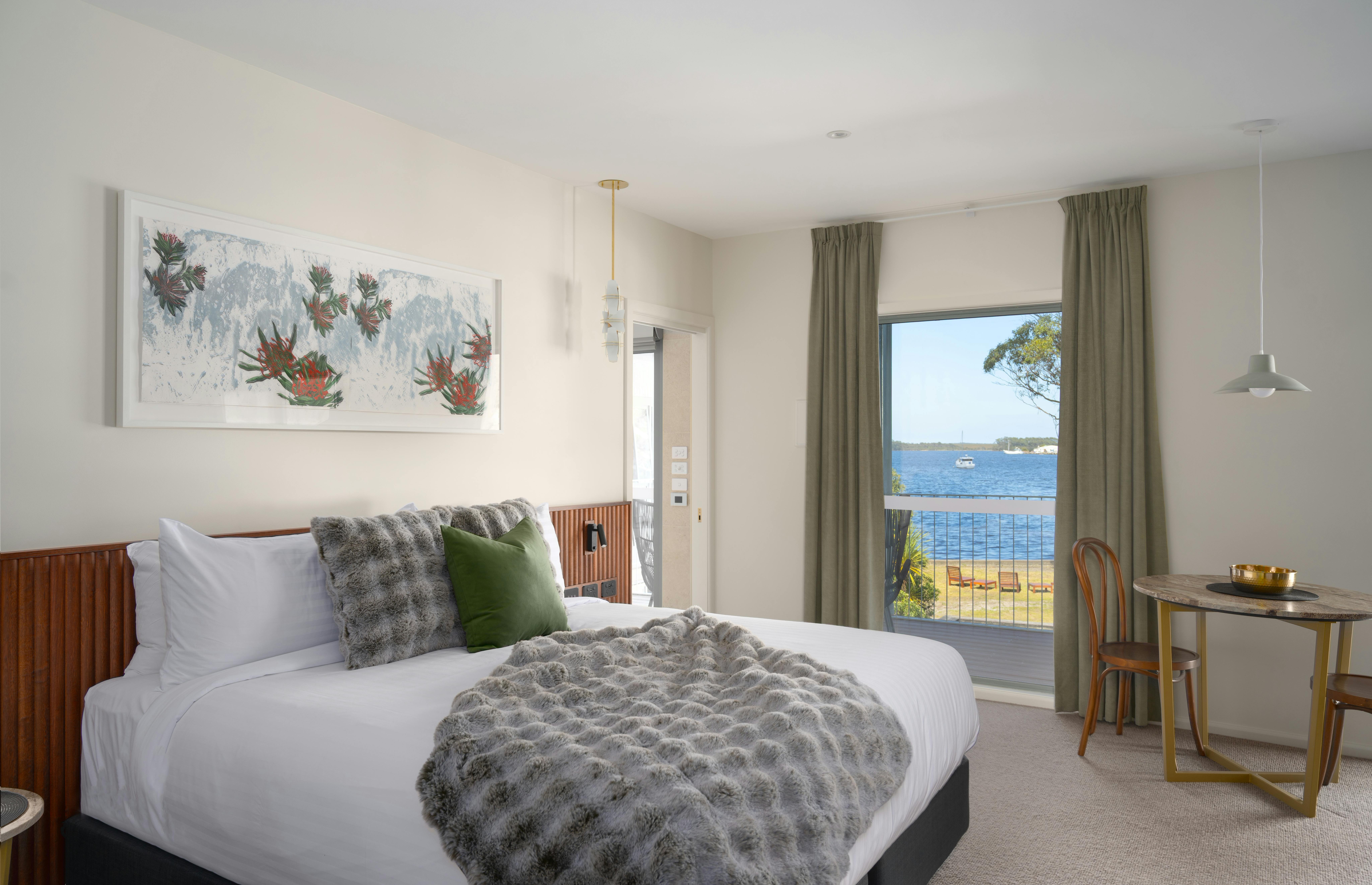 Beautifully appointed, luxurious suite with king bed, tasmanian artwork and a stunning harbour view