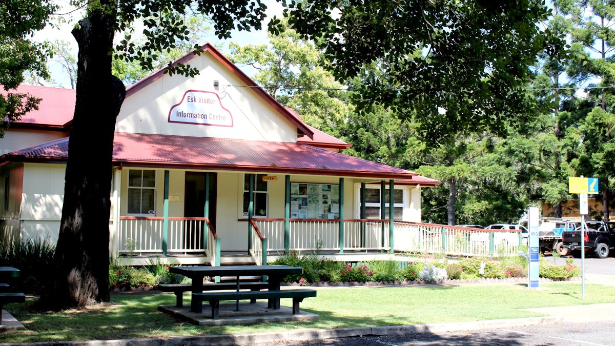 External View of the Esk Visitor Information Centre -  older building with wrap verandah, trees