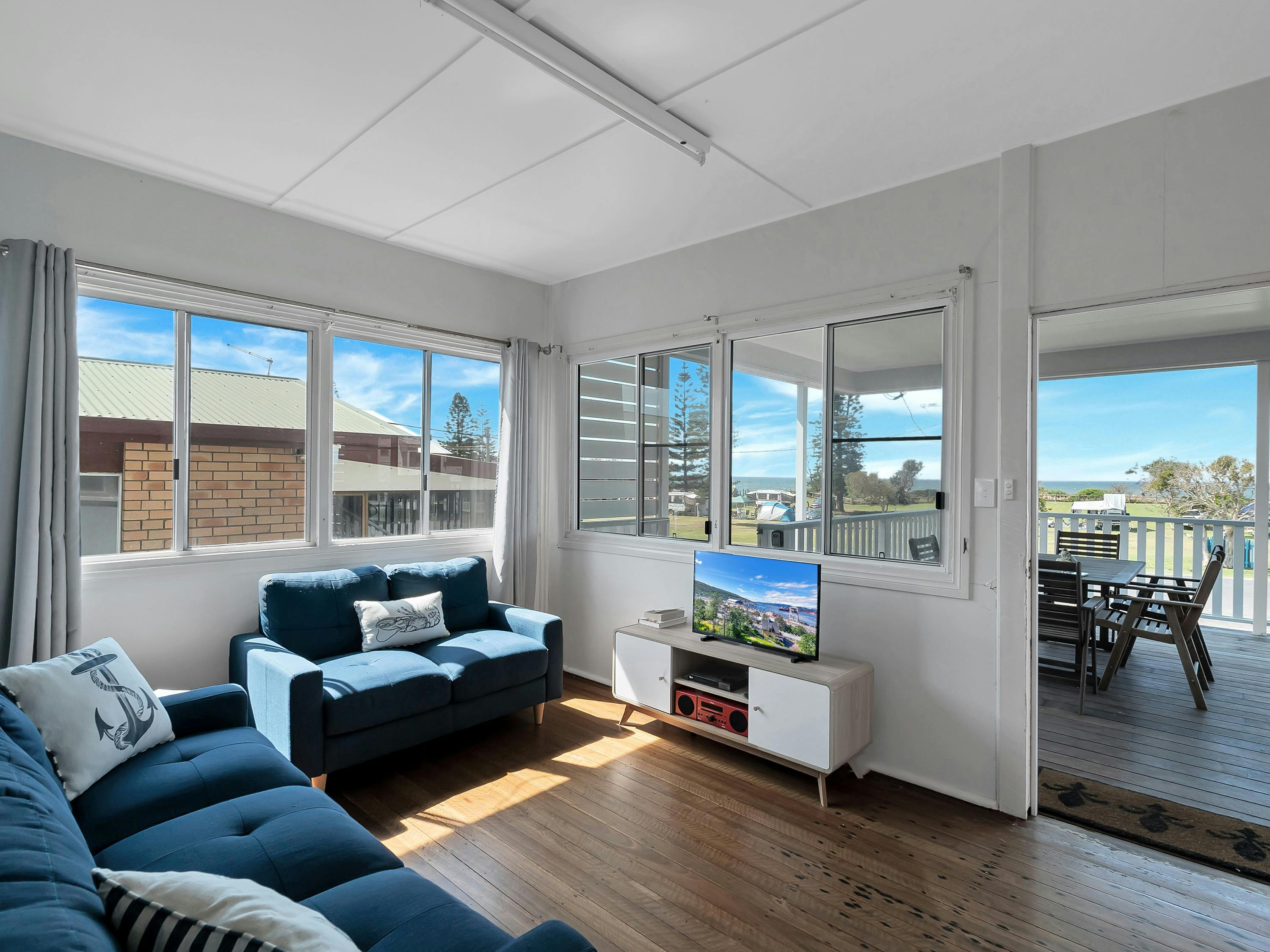Photo of the lounge area at the front of the house leading onto the deck.