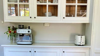 This light and spacious kitchen is ideal for cooking and meal prep with a central island bench
