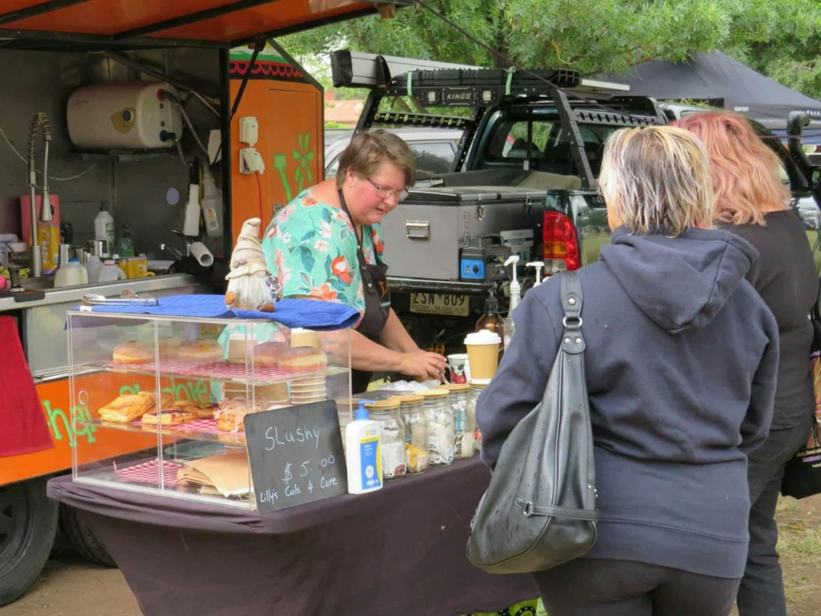 Lady serving food at Devenish Market