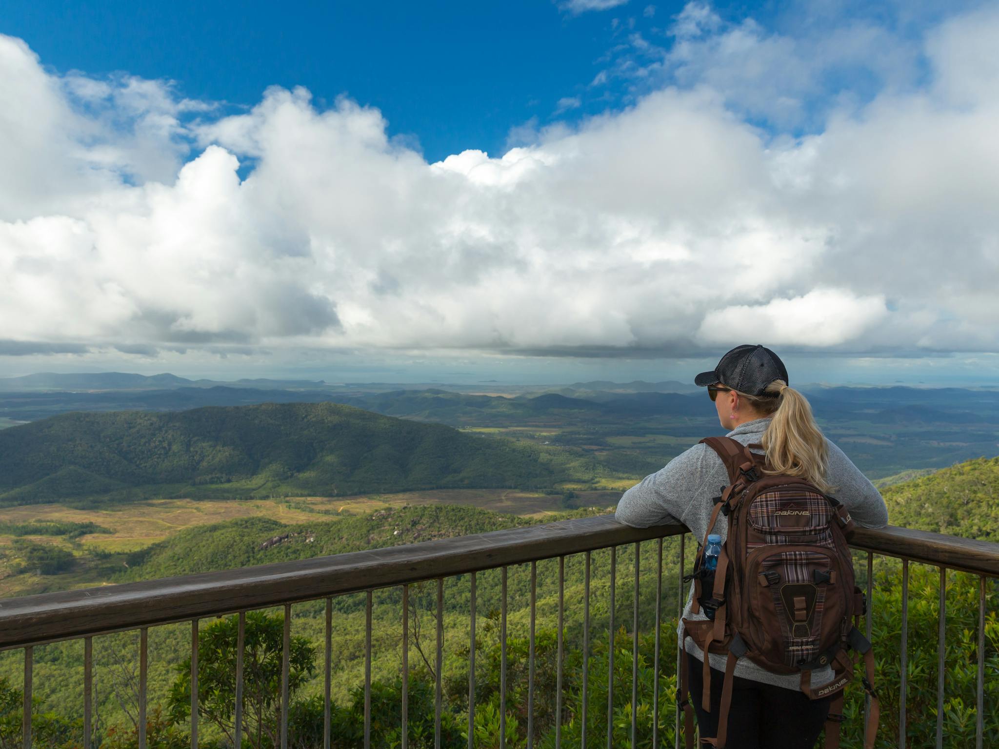 Person at lookout gazes at view over plain and distant mountains. Person at lookout gazes at view over plain and distant mountains.