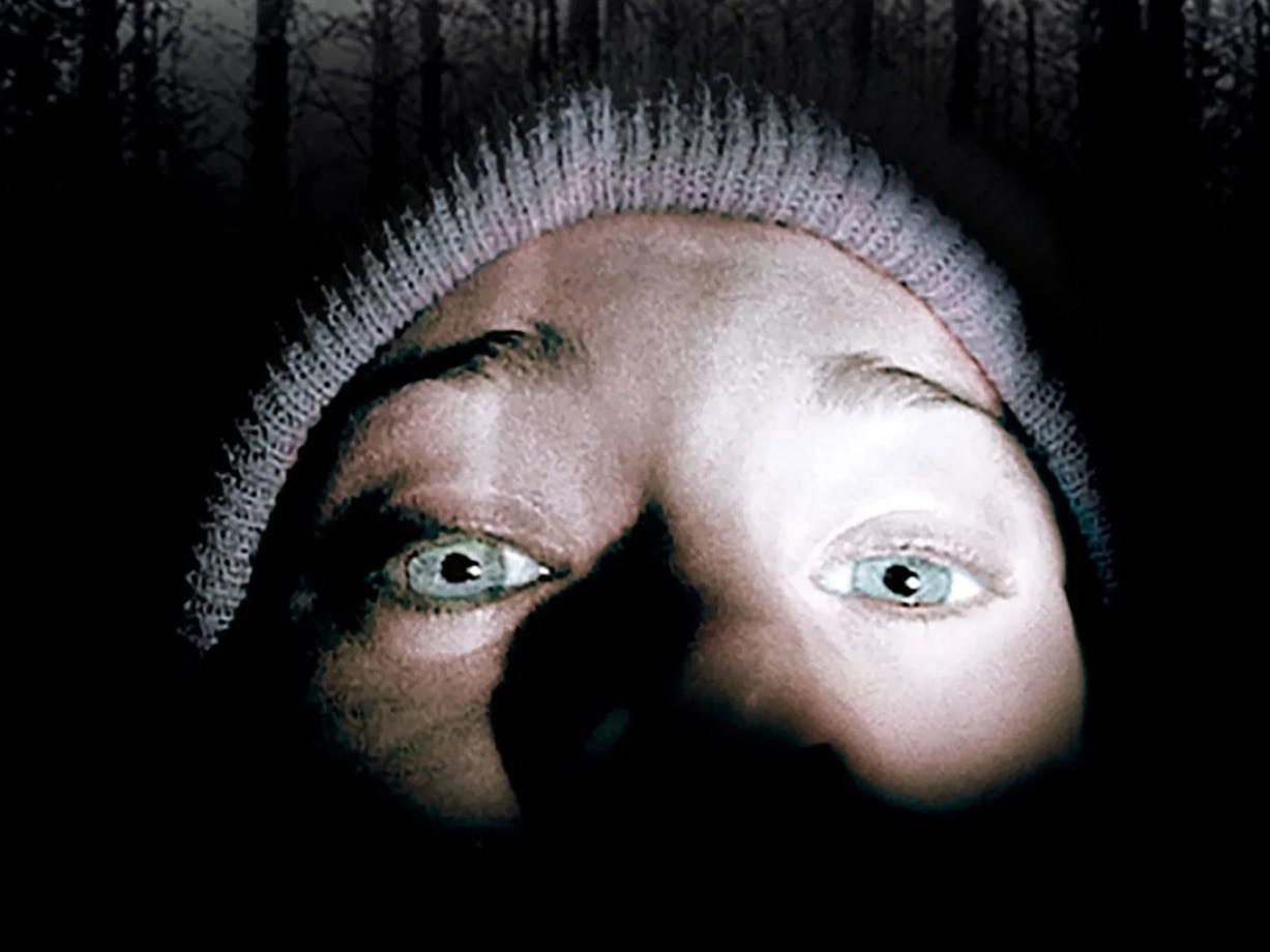 Close up of selfie image of a person wearing a beanie in the dark