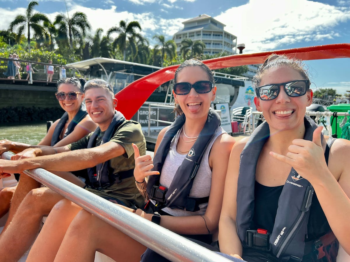 Guests in safety gear give the thumbs up before riding Bad Fishy Jet Boat through the Trinity Inlet