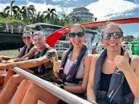 Guests in safety gear give the thumbs up before riding Bad Fishy Jet Boat through the Trinity Inlet