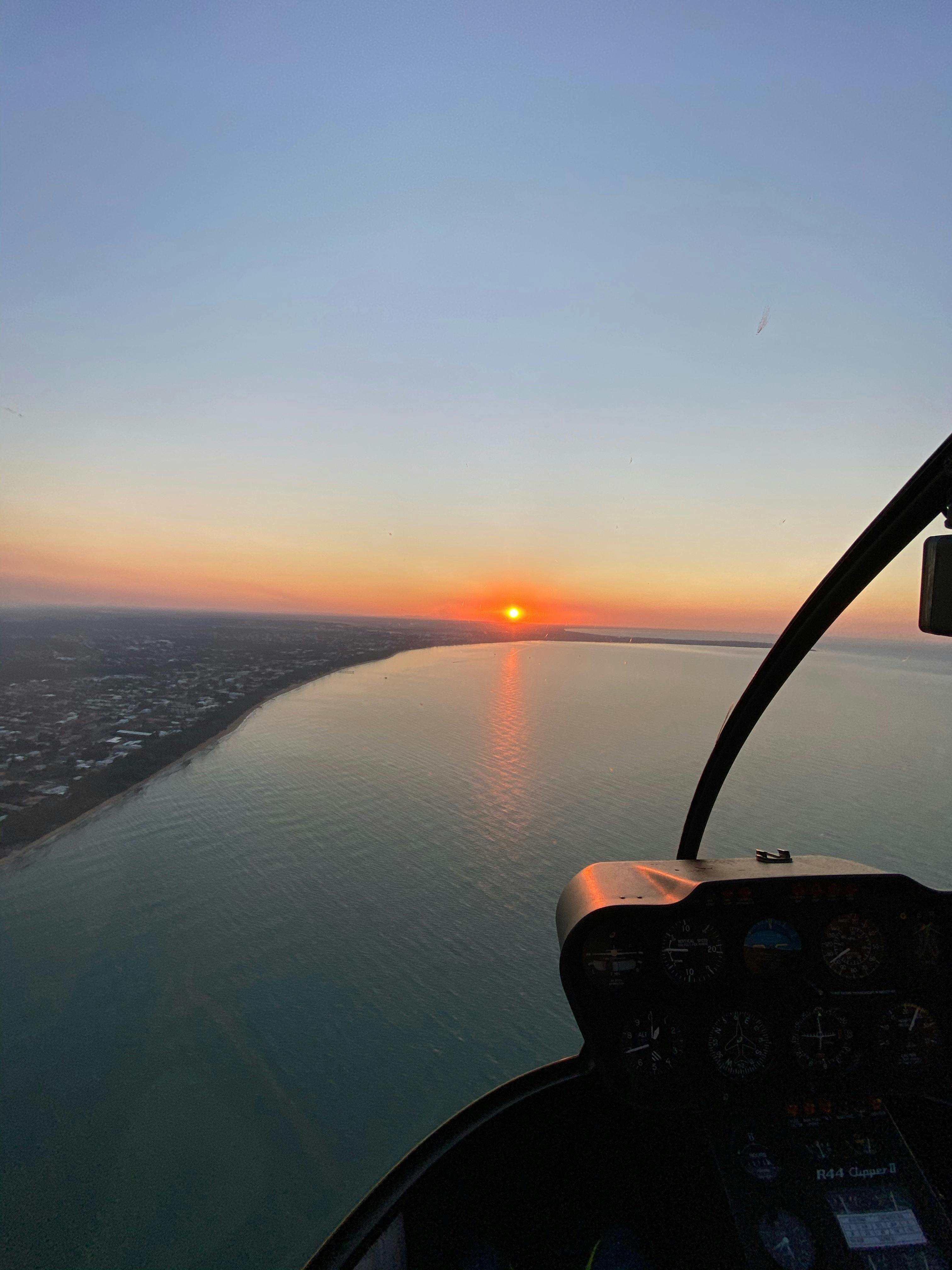 Helicopter Flying over Hervey Bay Beach on Sunset