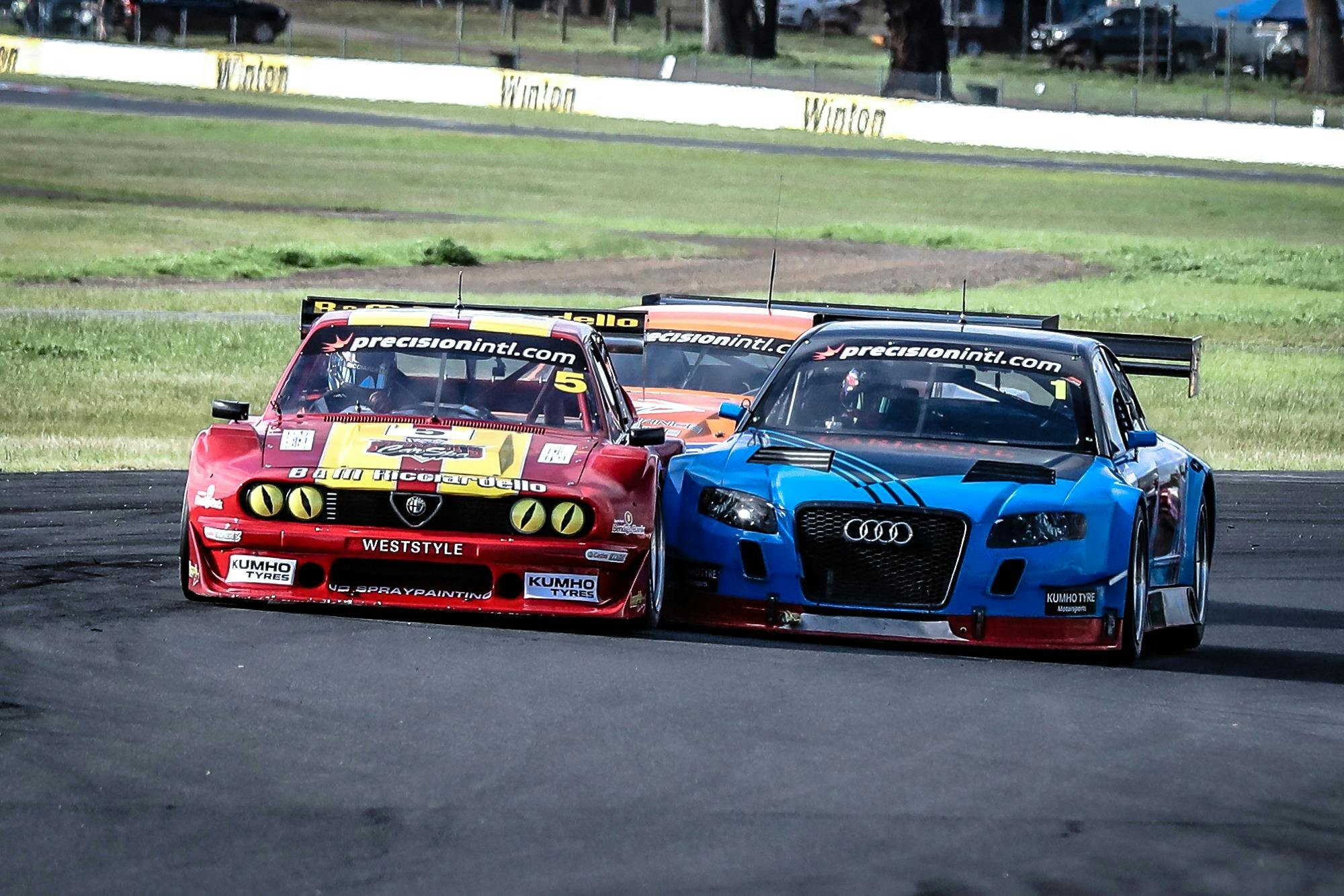 Two cars in close contact on a race track