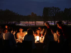 People dining amid a sea of colorful lights at the Field of Light Uluru