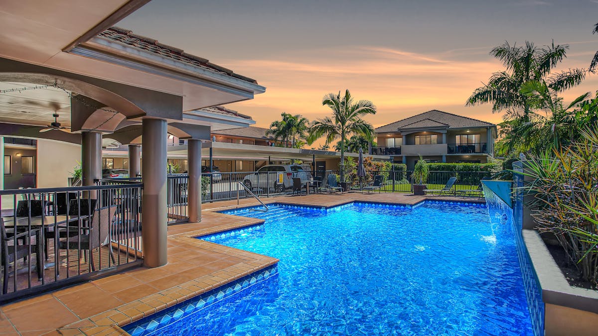 Resort style swimming pool with alfresco dining area
