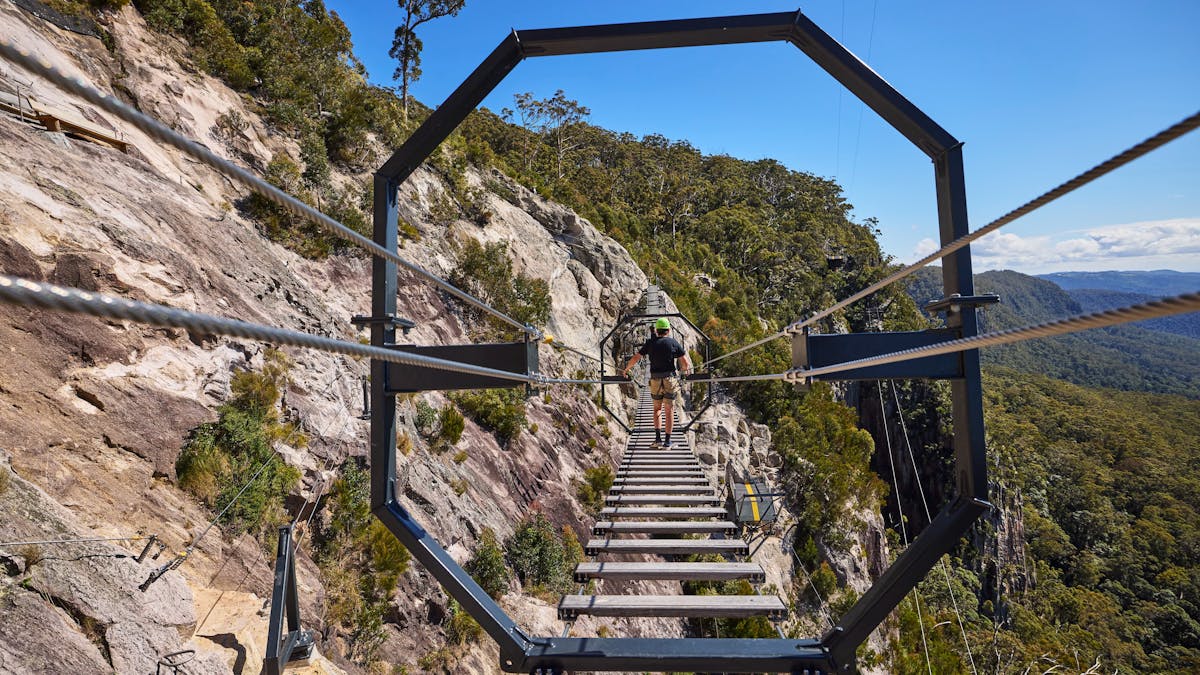 Man walking across Via Ferrata at Happitat Adventure Park