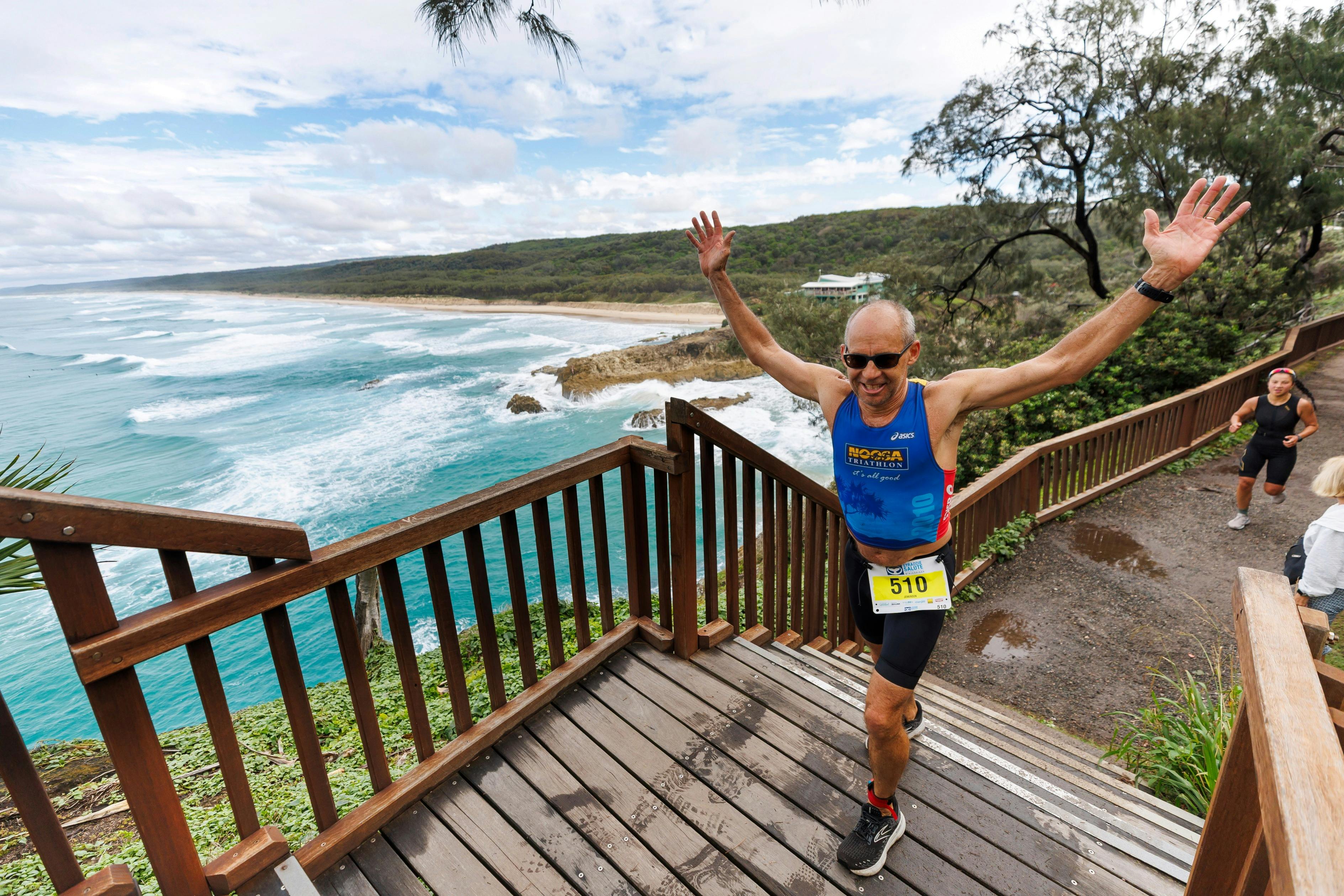 athlete running on boardwalk