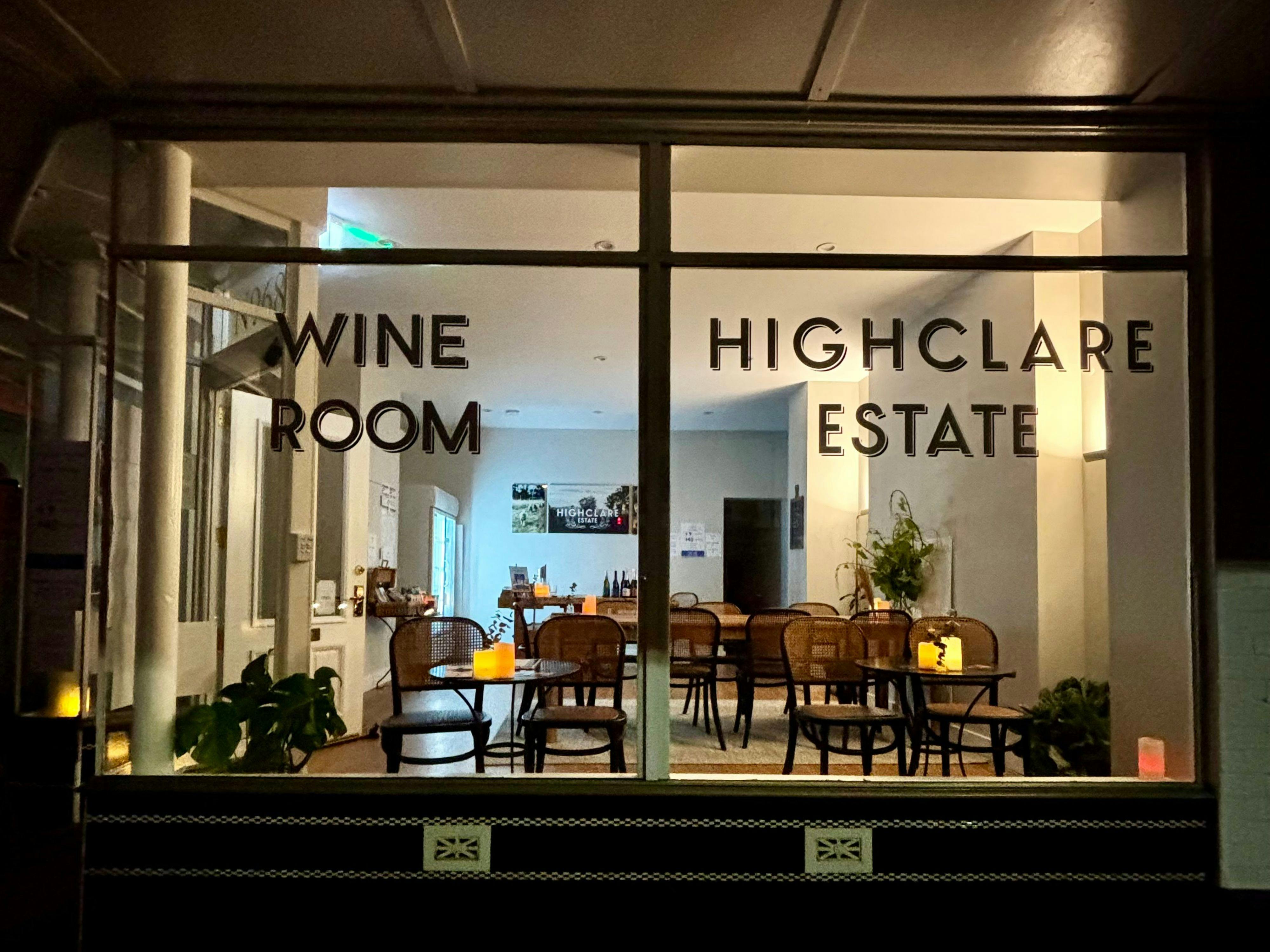 External view of Highclare Wine Room , art deco style window signage and view into seating beyond