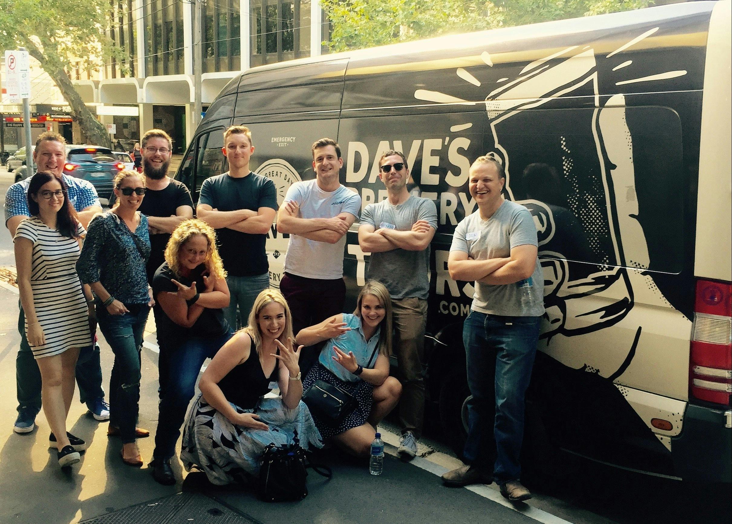Beer tour participants in front of the Dave's Brewery Tour bus