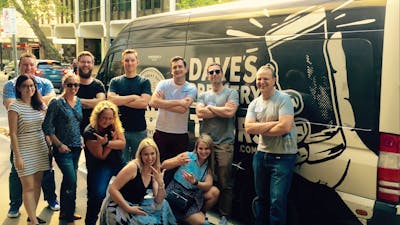 Beer tour participants in front of the Dave's Brewery Tour bus