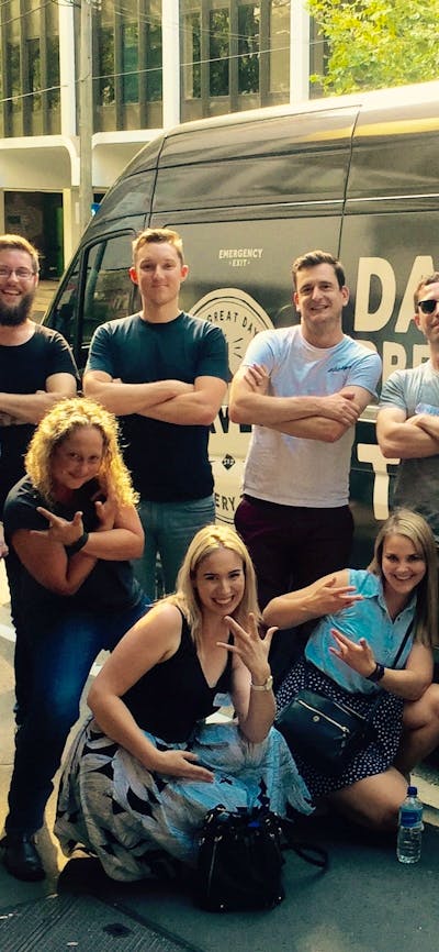 Beer tour participants in front of the Dave's Brewery Tour bus