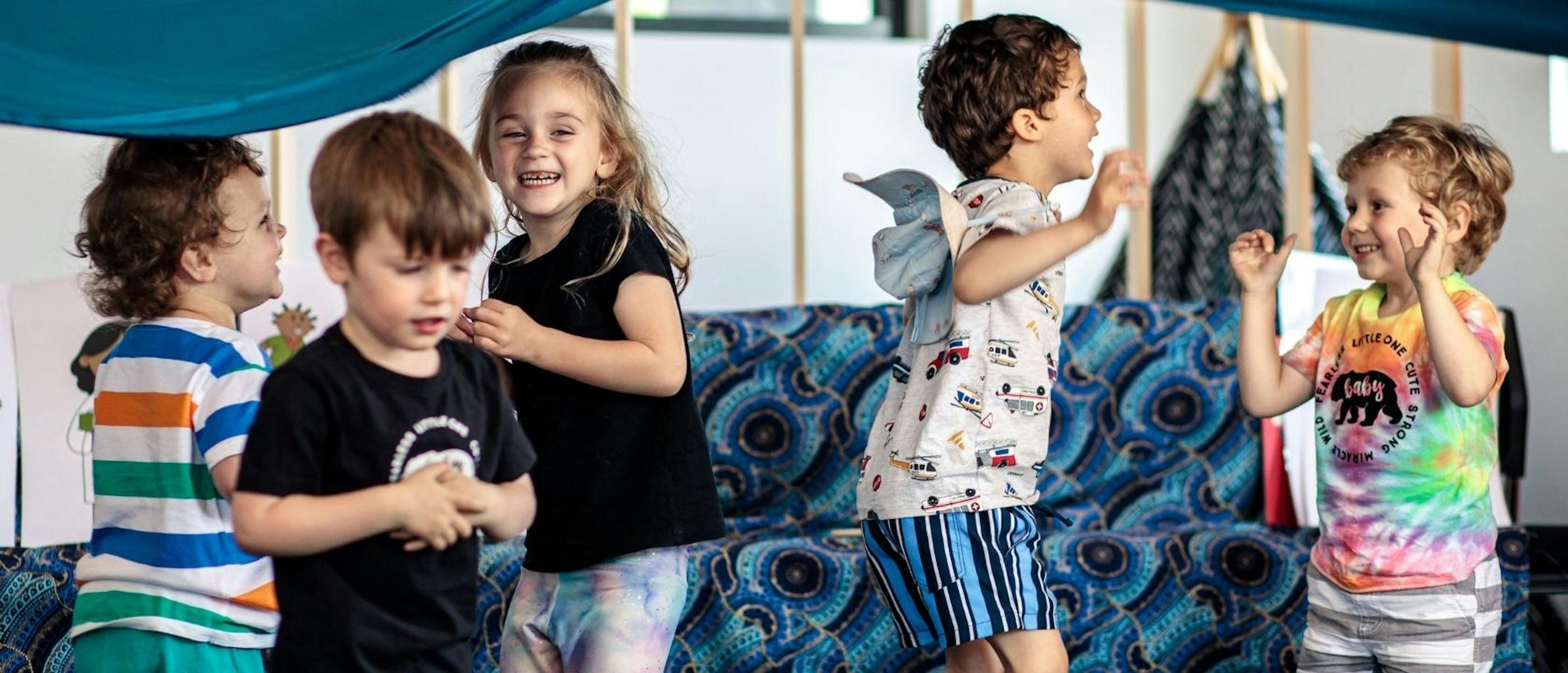 A group of children laughing and dancing