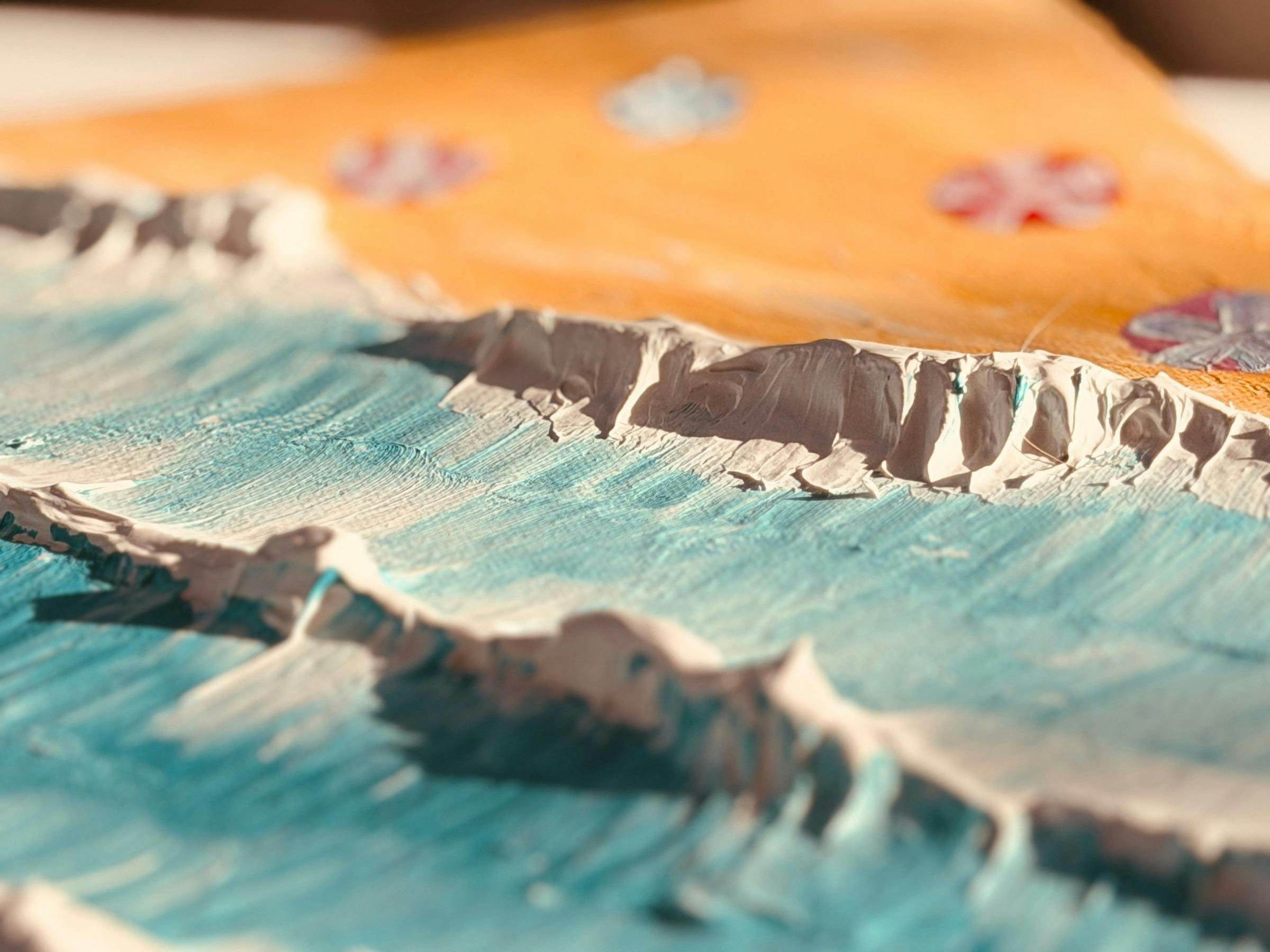 Angled view of a textured canvas showing raised paste ridges casting shadows