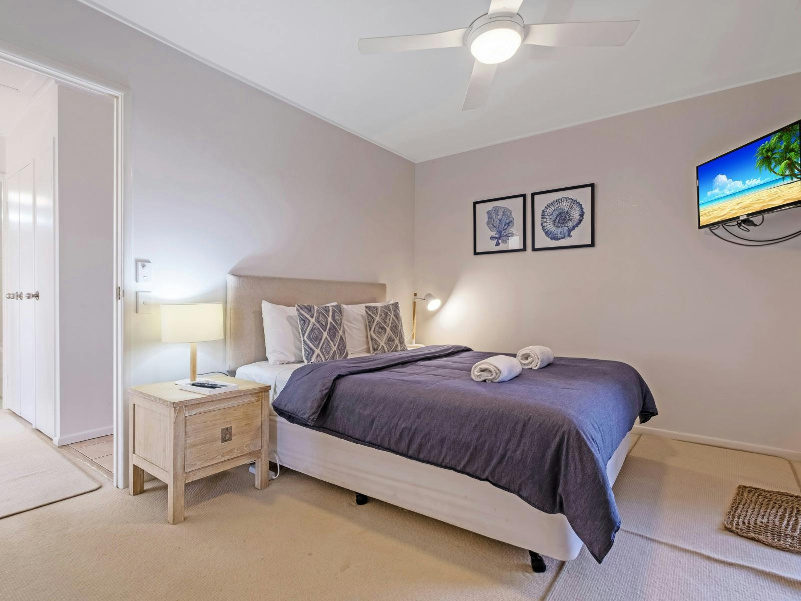 Main bedroom with ensuite, walk-in robe, TV and balcony access