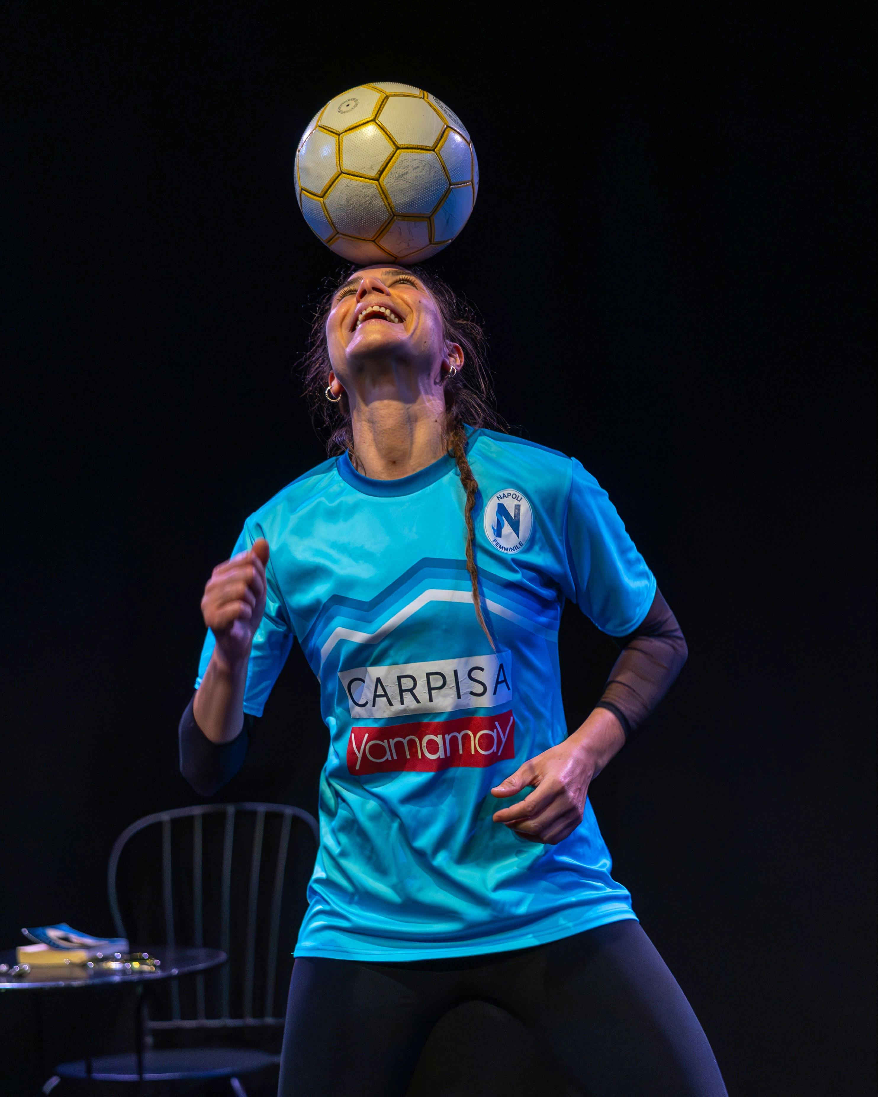 The SoccerActress balancing a soccer ball on her head