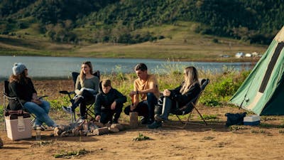 Family sitting around a fire place for lunch.