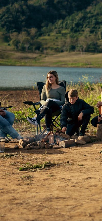 Family sitting around a fire place for lunch.